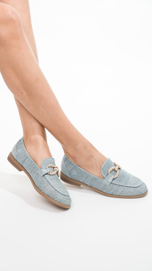 Manuella blue moccasins with buckles, showcasing a stylish design and soft leather texture.