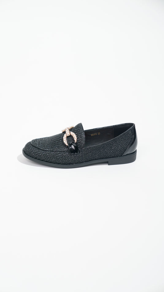 Manuella black moccasins with buckles, showcasing a stylish design and soft leather texture.